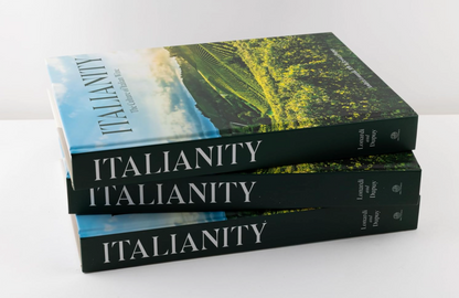 Three books titled 'Italianity' stacked on a white surface with a scenic cover.