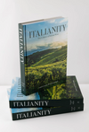 Stack of books titled 'Italianity' on a white surface with a vineyard image on the cover.