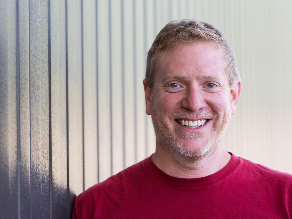 A man with light colored hair and blue eyes smiles at the camera. Picture credit: Tablas Creek.