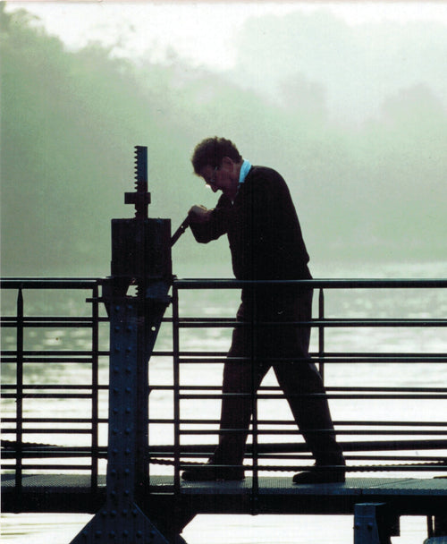 Nicholas Faith operates a machine in a bridge by the water