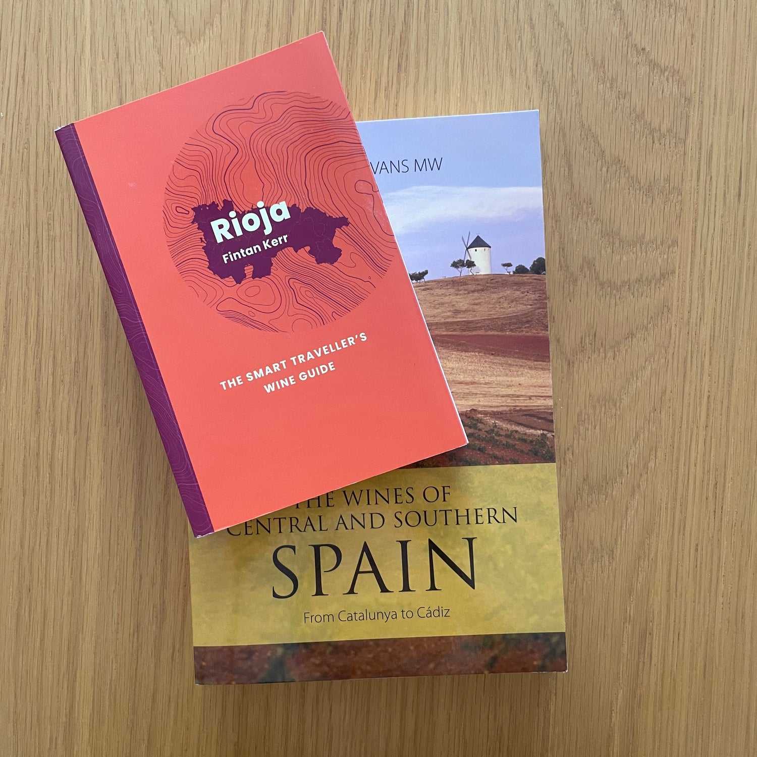 Two Spanish wine books on a wooden surface