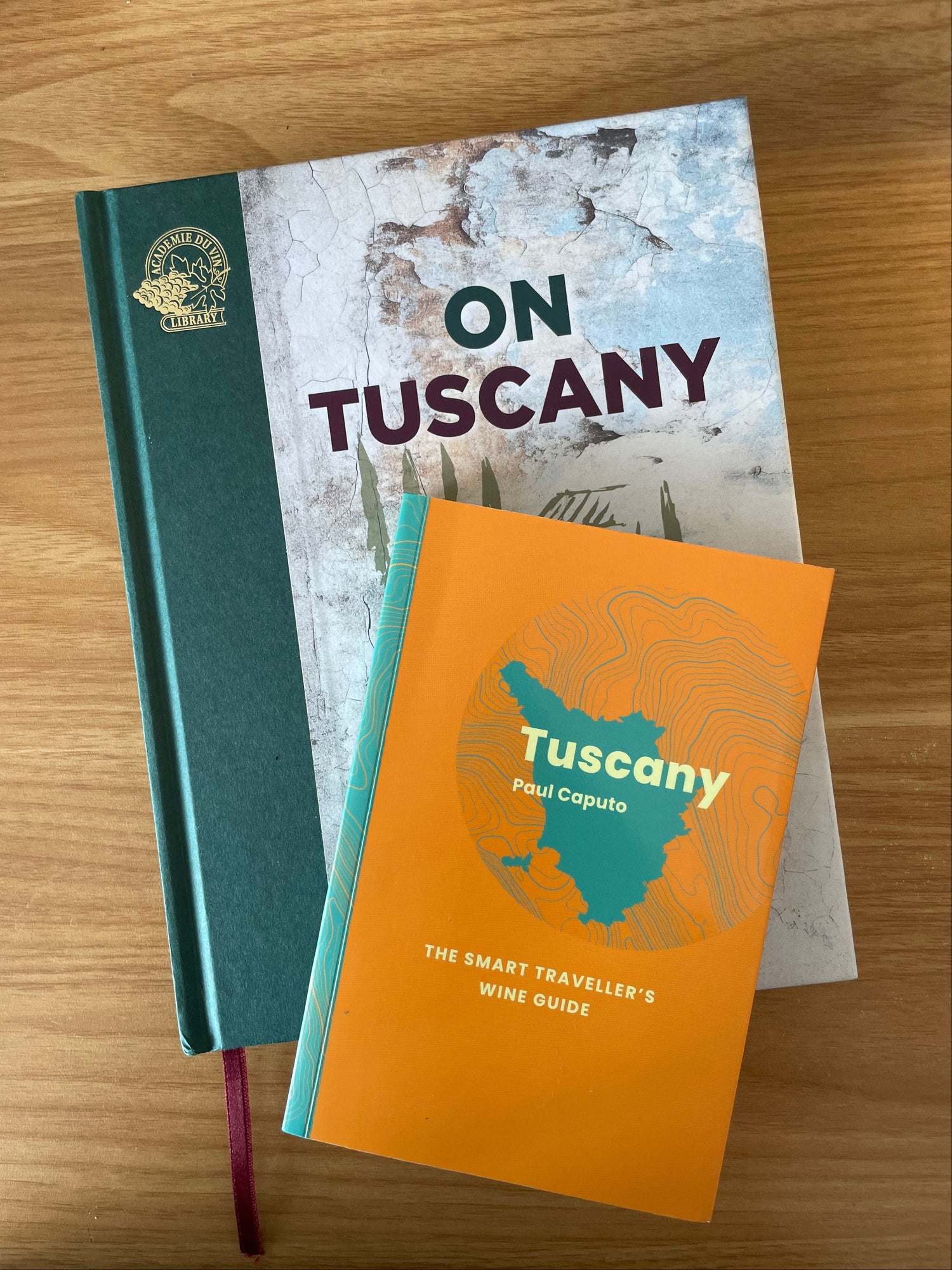 Two books on Tuscany on a wooden table
