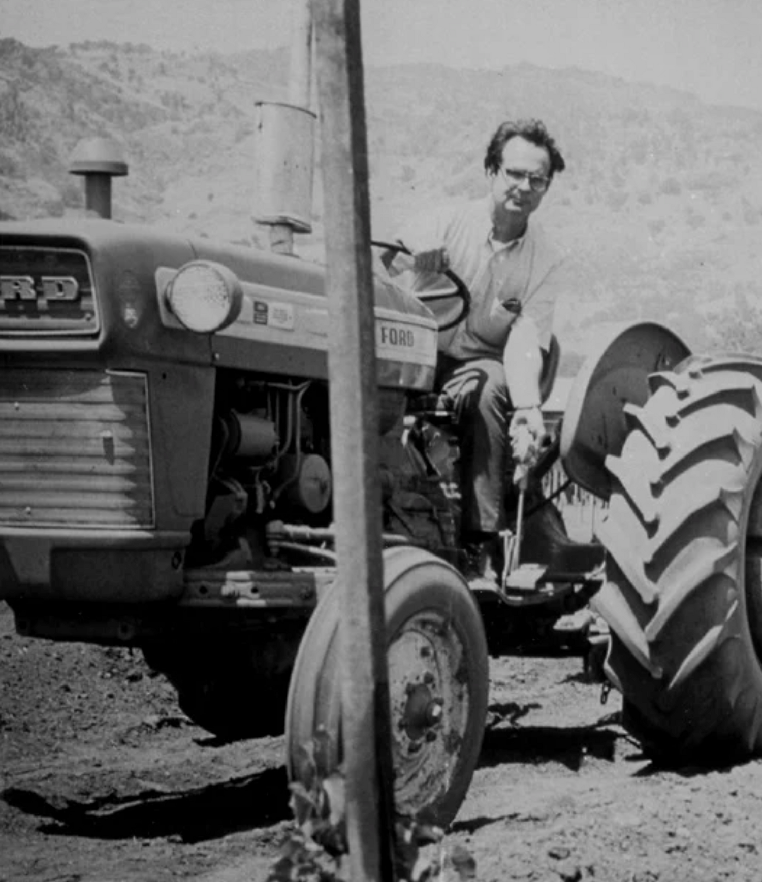 Winiarski sitting on a vintage tractor in a rural setting