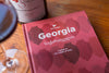 Image of Georgia book with a glass of wine